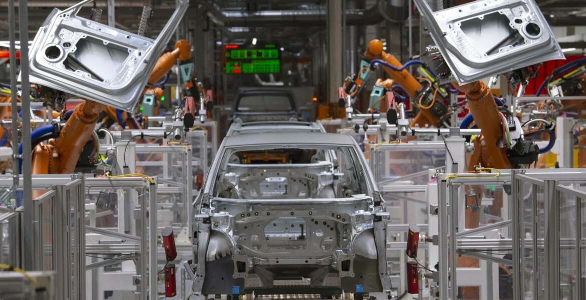 FILE- In this Tuesday, Feb. 25, 2020 file photo, robots work on an electric car ID.3 body at the assembly line during a press tour at the plant of the German manufacturer Volkswagen AG (VW) in Zwickau, Germany. The coronavirus has cancelled business plans all over the world but Europe's push into electric cars isn't one of them. Sales of battery-powered and hybrid cars have held up despite a deeply painful recession, mainly thanks to the action of governments. (AP Photo/Jens Meyer, file)
