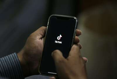 A man opens social media app 'Tik Tok' on his cell phone, in Islamabad, Pakistan, Tuesday, July 21, 2020. Pakistan has threatened the China-linked TikTok video service and blocked the Singapore-based Bigo Live streaming platform, citing what the regulating authority called widespread complaints about 