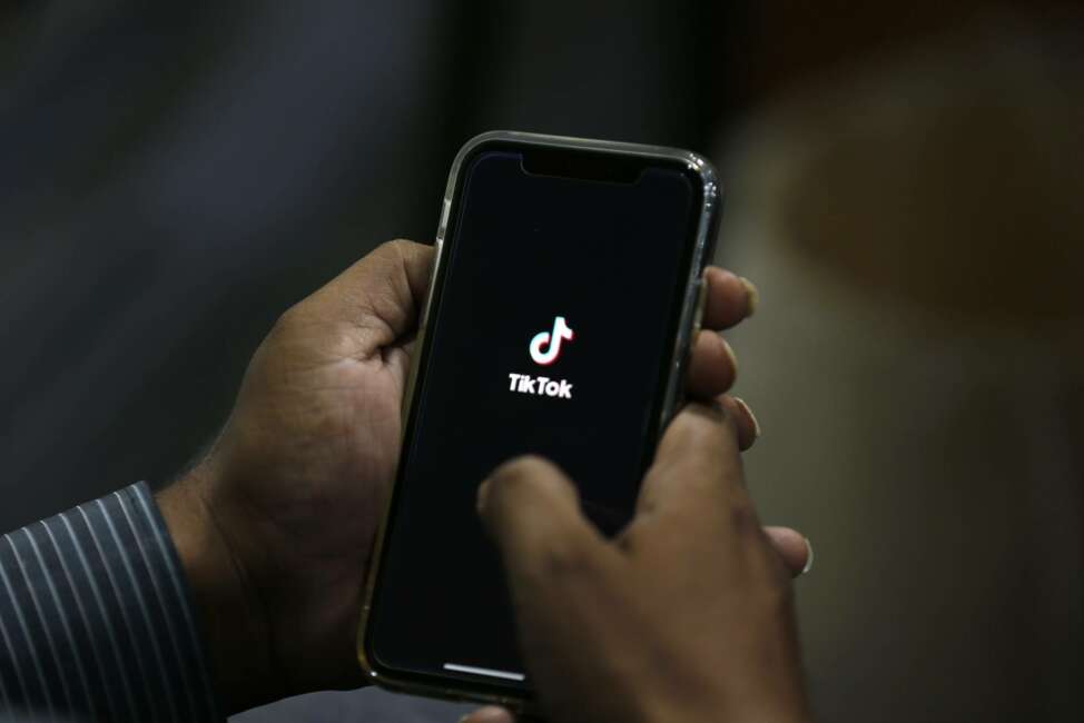 A man opens social media app 'Tik Tok' on his cell phone, in Islamabad, Pakistan, Tuesday, July 21, 2020. Pakistan has threatened the China-linked TikTok video service and blocked the Singapore-based Bigo Live streaming platform, citing what the regulating authority called widespread complaints about "immoral, obscene and vulgar" content. (AP Photo/Anjum Naveed)