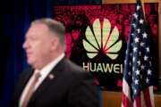 A monitor displays the logo for "Huawei" behind Secretary of State Mike Pompeo as he speaks during a news conference at the State Department in Washington, Wednesday, July 15, 2020. (AP Photo/Andrew Harnik, Pool)