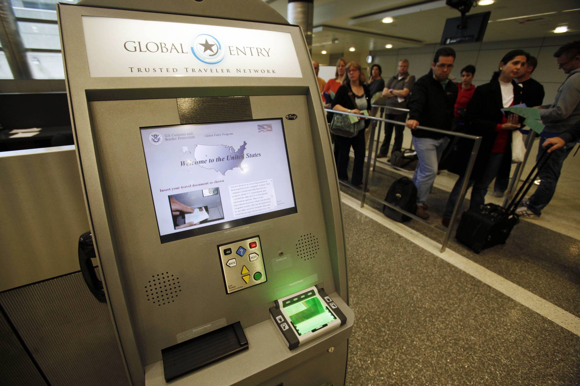 FILE - In this May 28, 2010, file photo, a Global Entry Trusted Traveler Network kiosk awaits arriving international passengers who are registered for the service at the Tom Bradley International Terminal at Los Angeles International Airport. On Thursday, July 23, 2020, the Department of Homeland Security announced that New Yorkers would once again be allowed to enroll and re-enroll in Global Entry and other federal travel programs that allow vetted travelers to avoid long security lines at the U.S. border. (AP Photo/Reed Saxon, File)