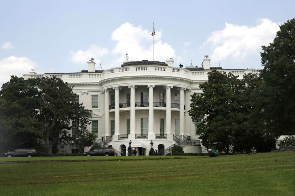 An American flag flies above the White House, Sunday, July 19, 2020, in Washington, a day after it flew at half-staff in remembrance of Rep. John Lewis, D-Ga. (AP Photo/Patrick Semansky)