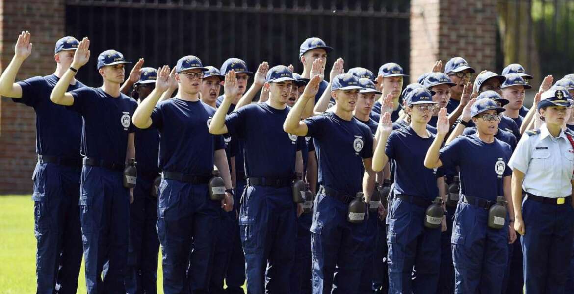 FILE — In this July 1, 2019 file photo, members of the U.S. Coast Guard Academy Class of 2023 take their oath of office on the first day of Swab Summer in New London, Conn. The school, like other service academies and military training centers, has made major changes because of the coronavirus pandemic. That means the eight weeks of boot camp for new cadets, known as 