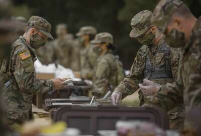 Soldiers in initial military training at Fort Jackson, S. C., line up to eat, May 11, 2020. (Victoria Evans)

