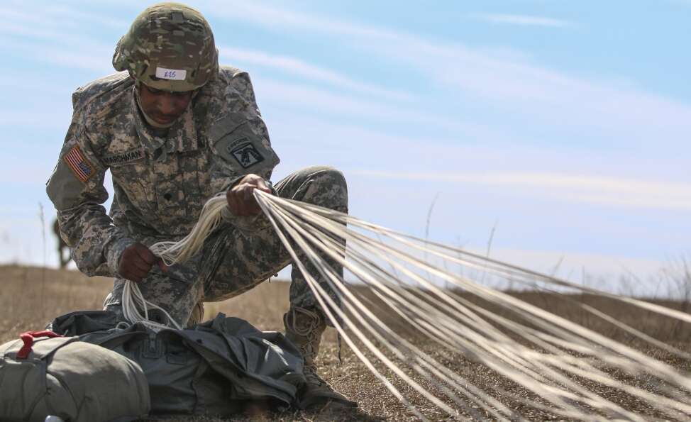 Spc. Adrian Marchman, a human resource specialist assigned to the XVIII Airborne Corps conducts “parachute recovery” after jumping from 1,200 feet during an Airborne assault at Sicily Drop Zone on Fort Bragg, N.C., Feb. 23, 2017.