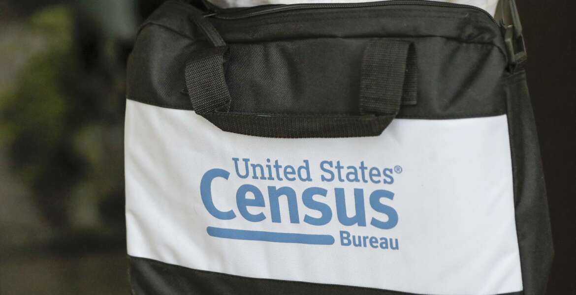 A briefcase of a census taker is seen as she knocks on the door of a residence Tuesday, Aug. 11, 2020, in Winter Park, Fla. A half-million census takers head out en mass this week to knock on the doors of households that haven't yet responded to the 2020 census. (AP Photo/John Raoux)