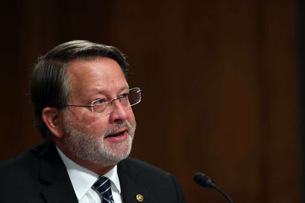 Senator Gary Peters, D-Mich., questions Department of Homeland Security Acting Secretary Chad Wolf during a Senate Homeland Security and Governmental Affairs Committee hearing to examine Department of Homeland Security personnel deployments to recent protests on Thursday, Aug. 6, 2020, in Washington. (Toni Sandys/The Washington Post via AP, Pool)