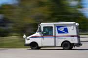 A mail truck moves down a street Tuesday, Aug. 18, 2020, in Fox Point, Wis. Facing public pressure and state lawsuits, the Postmaster general announced Tuesday he is halting some operational changes to mail delivery that critics warned were causing widespread delays and could disrupt voting in the November election. (AP Photo/Morry Gash)