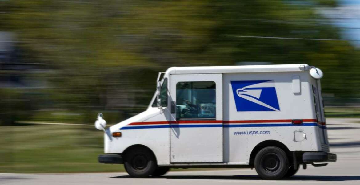 A mail truck moves down a street Tuesday, Aug. 18, 2020, in Fox Point, Wis. Facing public pressure and state lawsuits, the Postmaster general announced Tuesday he is halting some operational changes to mail delivery that critics warned were causing widespread delays and could disrupt voting in the November election. (AP Photo/Morry Gash)