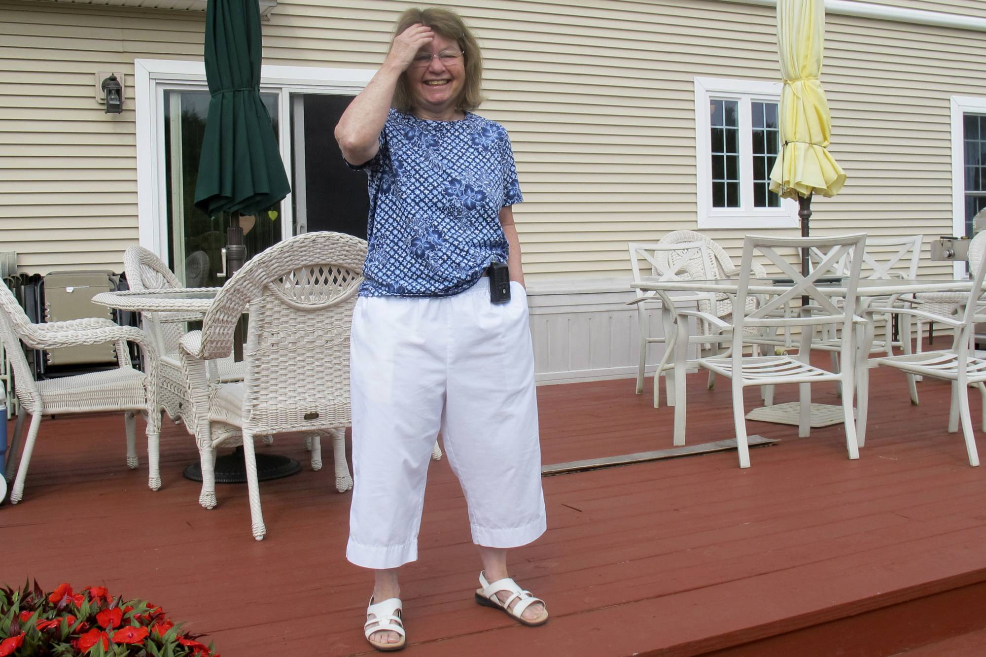 In this Aug. 24, 2020, photo Jean Grady smiles as she poses at her home in Westford, Vt. Grady wears an insulin pump to help manage her diabetes. Before the pandemic, Medicare rules required her make regular two-hour, one-way trips to New Hampshire to meet with her doctor to discuss her treatment. Medicare rule changes during the pandemic now makes it possible for her to meet with her doctor remotely, saving her from hours on the road. (AP Photo/Wilson Ring)