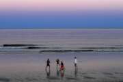 A group of people play Spikeball at twilight on the beach, Thursday, Aug. 7, 2020, in Ocean Park, Maine. As the summer tourist season reaches its peak Maine's coronavirus positivity rate remains among the lowest in the nation. (AP Photo/Robert F. Bukaty)