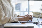 The hand of a young woman working at remote work