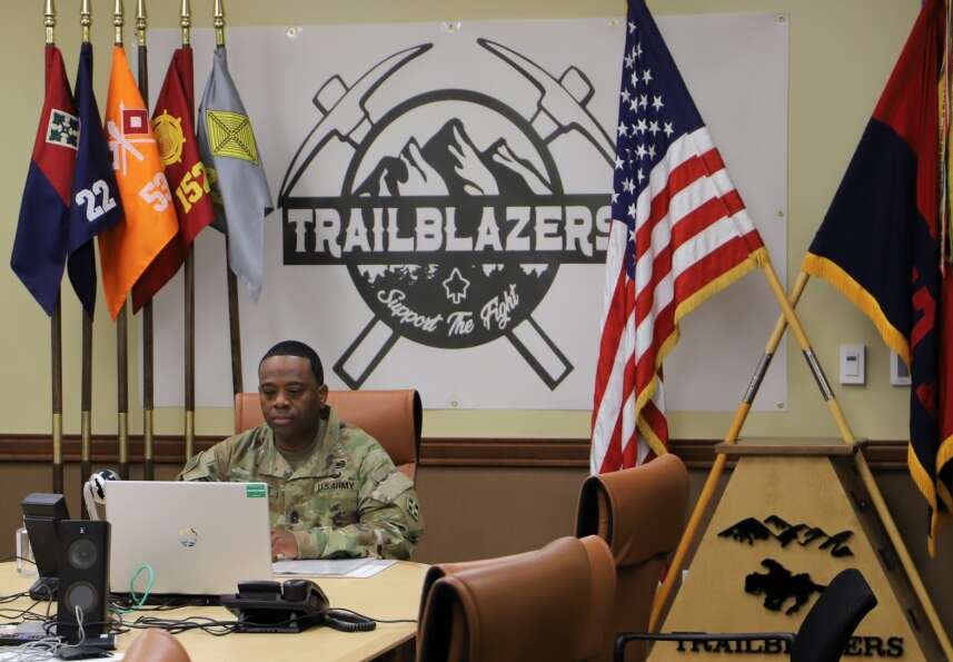 Command Sgt. Maj. Johnny Bryant, battalion sergeant major and president of the board, 4th Special Troops Battalion, 4th Sustainment Brigade, 4th Infantry Division listens to a Soldier’s response during 4STB’s virtual promotion board 29 April at the brigade headquarters building on Fort Carson, Colorado. The board members communicated with the Soldiers and their sponsors through video teleconference. (U.S. Army photo by Sgt. James Geelen, 4th Sustainment Brigade Public Affairs Office, 4th Infantry Division)


