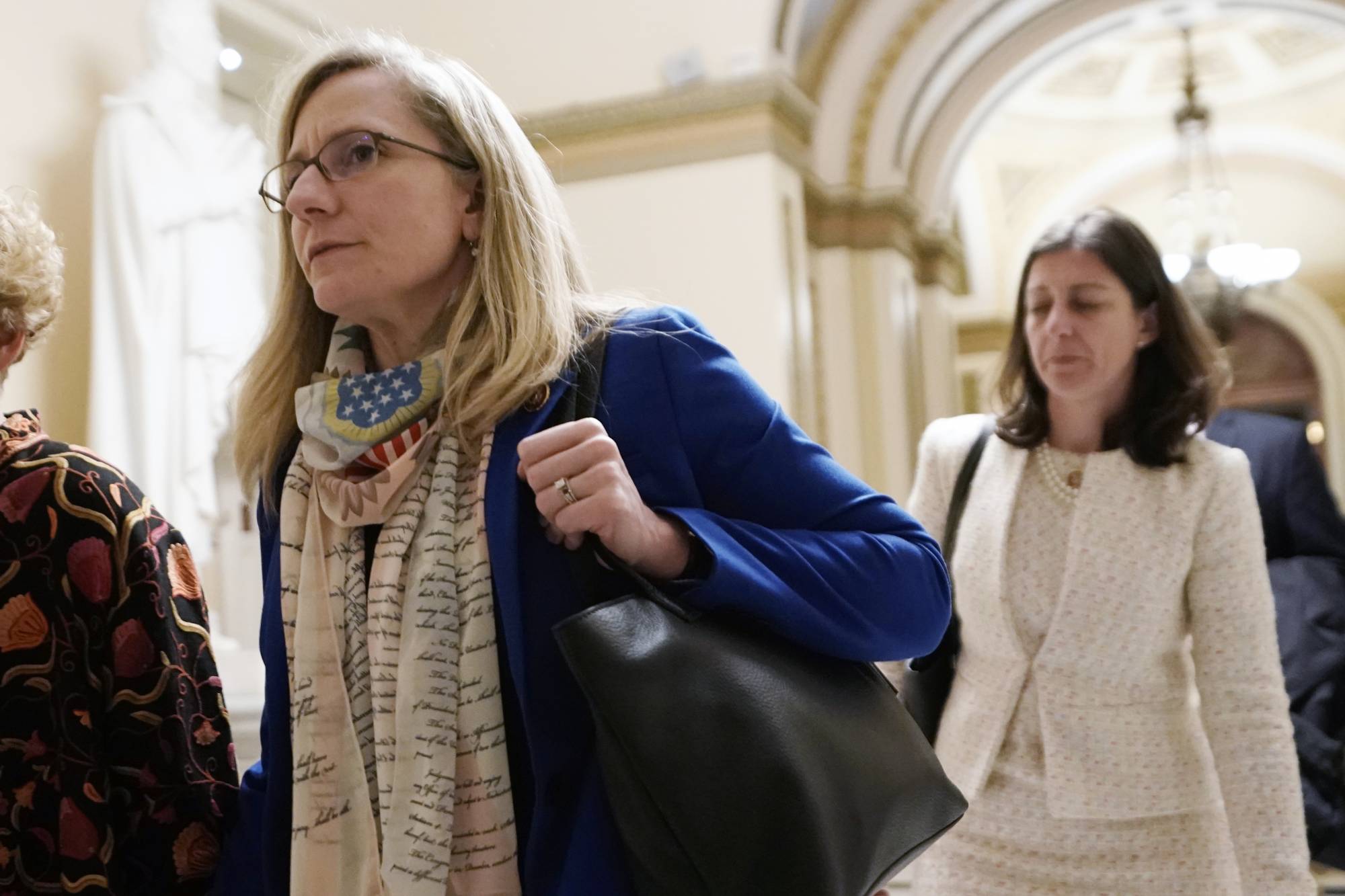 FILE - In this Dec. 18, 2019 file photo, Rep Abigail Spanberger D-Va., left, and Rep Elaine Luria. D-Va., walk at the Capitol in Washington. The U.S. Chamber of Commerce has decided to endorse 23 freshmen House Democrats in this fall’s elections. The move represents a gesture of bipartisanship by the nation's largest business organization, which has long leaned strongly toward Republicans. (AP Photo/J. Scott Applewhite)