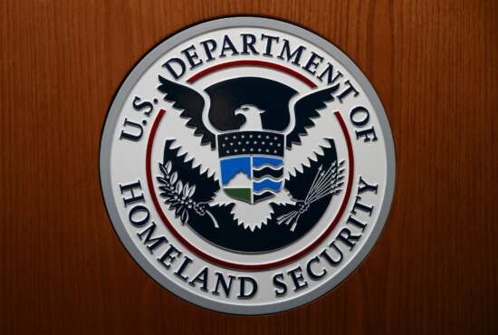FILE - In this June 28, 2019, file photo the Department of Homeland Security (DHS) seal is seen during a news conference in Washington. An official at the Department of Homeland Security says he was pressured by agency leaders to suppress details in his intelligence reports that President Donald Trump might find objectionable, including intelligence on Russian interference in the election and the threat posed by white supremacists. (AP Photo/Carolyn Kaster, File)