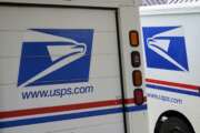 FILE - In this Aug. 18, 2020, file photo, mail delivery vehicles are parked outside a post office in Boys Town, Neb. A U.S. judge on Thursday, Sept. 17, 2020, blocked controversial Postal Service changes that have slowed mail nationwide. The judge called them "a politically motivated attack on the efficiency of the Postal Service" before the November election. (AP Photo/Nati Harnik, File)