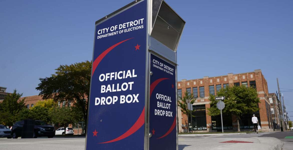 FILE - In this Thursday, Sept. 24, 2020, file photo, a ballot drop box is shown where voters can drop off absentee ballots instead of using the mail outside the Detroit Pistons training facility in Detroit. NFL, NBA, NHL, Major League Baseball and college venues are serving various roles in unprecedented ways, including providing space for people to vote while social distancing on Election Day. (AP Photo/Paul Sancya, File)