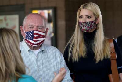 Ivanka Trump, right, and Secretary of Agriculture Sonny Perdue, left, speak with a farming family during a visit to the North Carolina State Farmers Market in Raleigh, N.C., Thursday, Sept. 10, 2020. (AP Photo/Gerry Broome)