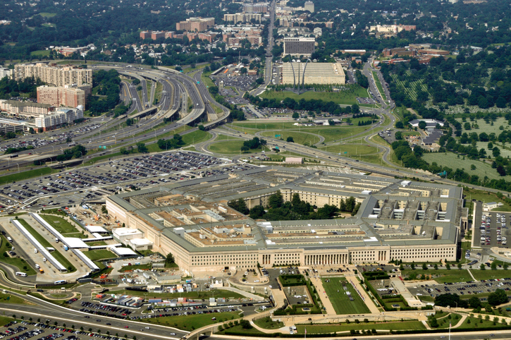 Aerial of the Pentagon, the Department of Defense headquarters in Arlington, Virginia, near Washington DC, with I-395 freeway on the left, and the Air Force Memorial up middle.