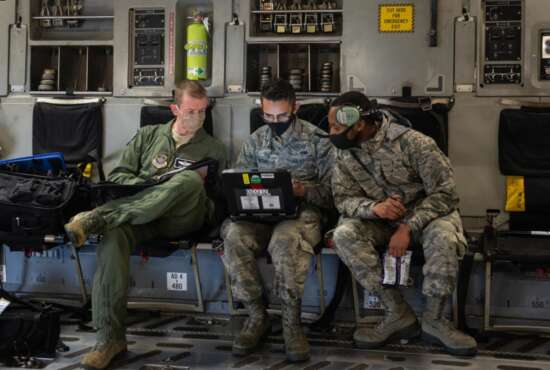 Maj. Philip Becker, 8th Airlift Squadron pilot, left, works with 62nd Aircraft Maintenance Squadron Airmen to complete preflight checks at Joint Base Lewis-McChord, Wash., Aug. 6, 2020. The flight was part of Exercise Long Hammer/Rainier War, a week-long exercise designed to evaluate Team McChord’s ability to conduct airlift operations while complying with real-world COVID-19 pandemic countermeasures. (U.S. Air Force photo by Senior Airman Sara Hoerichs)