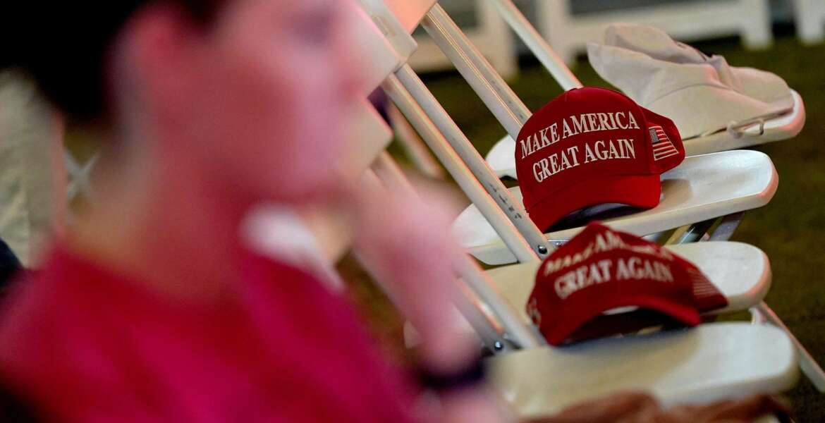 MAGA hats sit on empty seats during an election watch party, Tuesday, Nov. 3, 2020, in Chandler, Ariz. (AP Photo/Matt York)