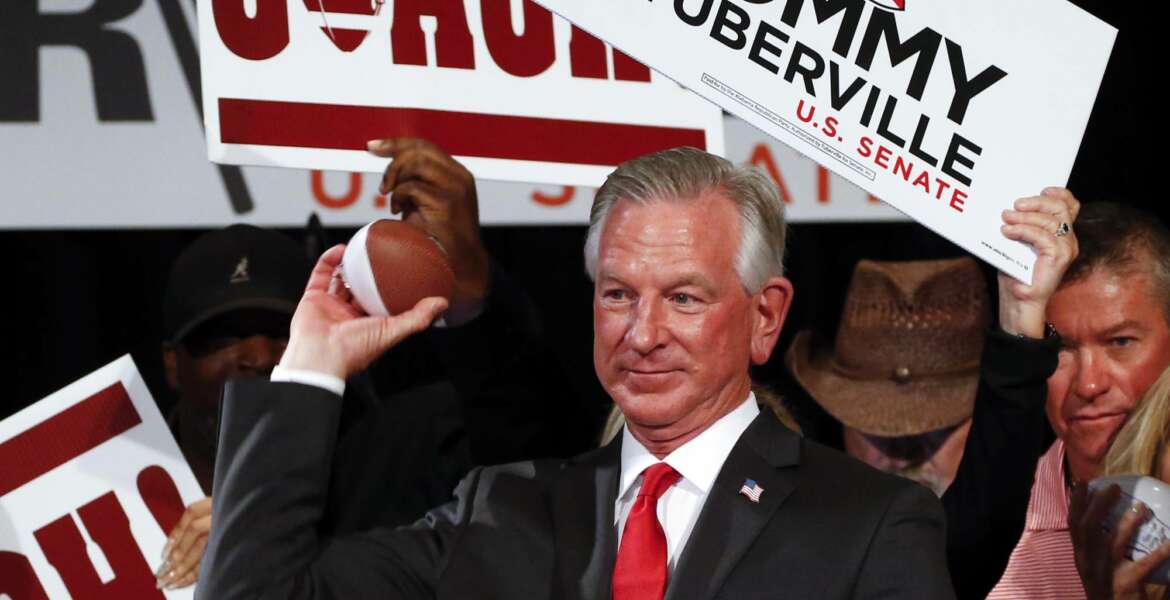 Republican Senator-elect Tommy Tuberville throws toy footballs to supporters at his watch party at the Renaissance Hotel on Tuesday, Nov. 3, 2020, in Montgomery, Ala. (AP Photo/Butch Dill)