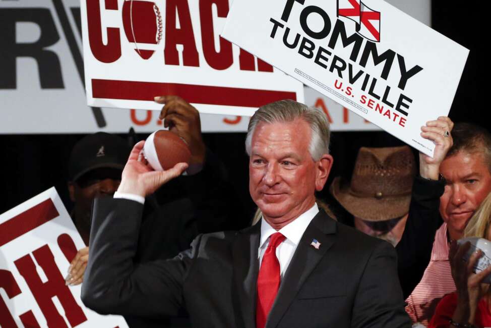 Republican Senator-elect Tommy Tuberville throws toy footballs to supporters at his watch party at the Renaissance Hotel on Tuesday, Nov. 3, 2020, in Montgomery, Ala. (AP Photo/Butch Dill)