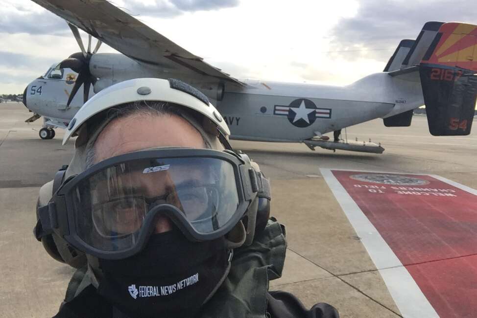 Tom Temin, with cranial on, ready to board stubby Grumman C-2 to embark on the U.S.S. Gerald R. Ford