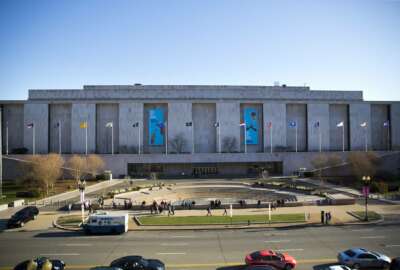 FILE - In this April 3, 2019, file photo people visit the Smithsonian Museum of American History on the National Mall at 14th Street and Constitution Ave., in Washington. In response to rising COVID-19 infection numbers, the Smithsonian Institution is indefinitely shutting down operations at all its facilities, effective Monday and affecting seven museums, plus the National Zoo. (AP Photo/Pablo Martinez Monsivais, File)