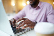 Hands of businessman or designer typing on l aptop