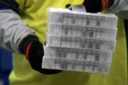 Boxes containing the Pfizer-BioNTech COVID-19 vaccine are prepared to be shipped at the Pfizer Global Supply Kalamazoo manufacturing plant in Portage, Mich., Sunday, Dec. 13, 2020. (AP Photo/Morry Gash, Pool)