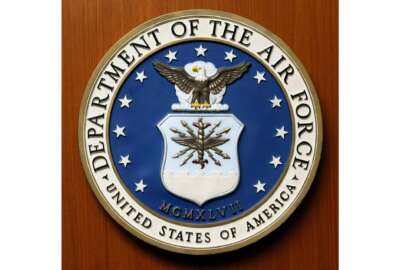 FILE - This Friday, Aug. 10, 2007, file photo, shows the logo of the Department of the U.S. Air Force at the United Staes embassy, in Berlin. A new report issued Monday, Dec. 21, 2020, on racial disparities in the Air Force concludes that Black service members in the service are far more likely to be investigated, arrested, face disciplinary actions, and be discharged for misconduct. (AP Photo/Michael Sohn, File)