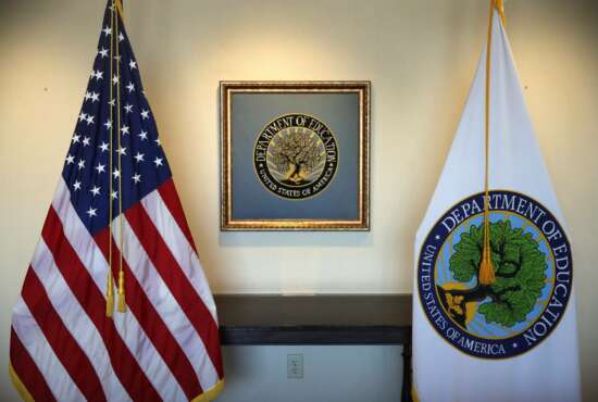 FILE - In this Aug. 9, 2017, photo, flags decorate a space outside the office of the Education Secretary at the Education Department in Washington. President-elect Joe Biden has chosen the education commissioner for Connecticut and a former public school teacher to serve as education secretary. (AP Photo/Jacquelyn Martin)