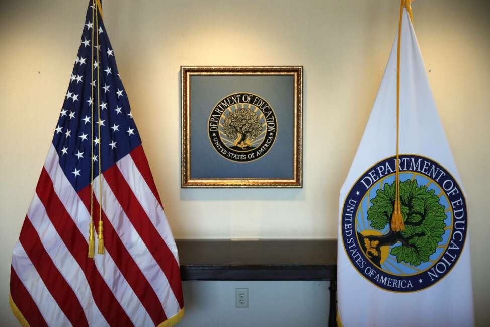 FILE - In this Aug. 9, 2017, photo, flags decorate a space outside the office of the Education Secretary at the Education Department in Washington. President-elect Joe Biden has chosen the education commissioner for Connecticut and a former public school teacher to serve as education secretary. (AP Photo/Jacquelyn Martin)