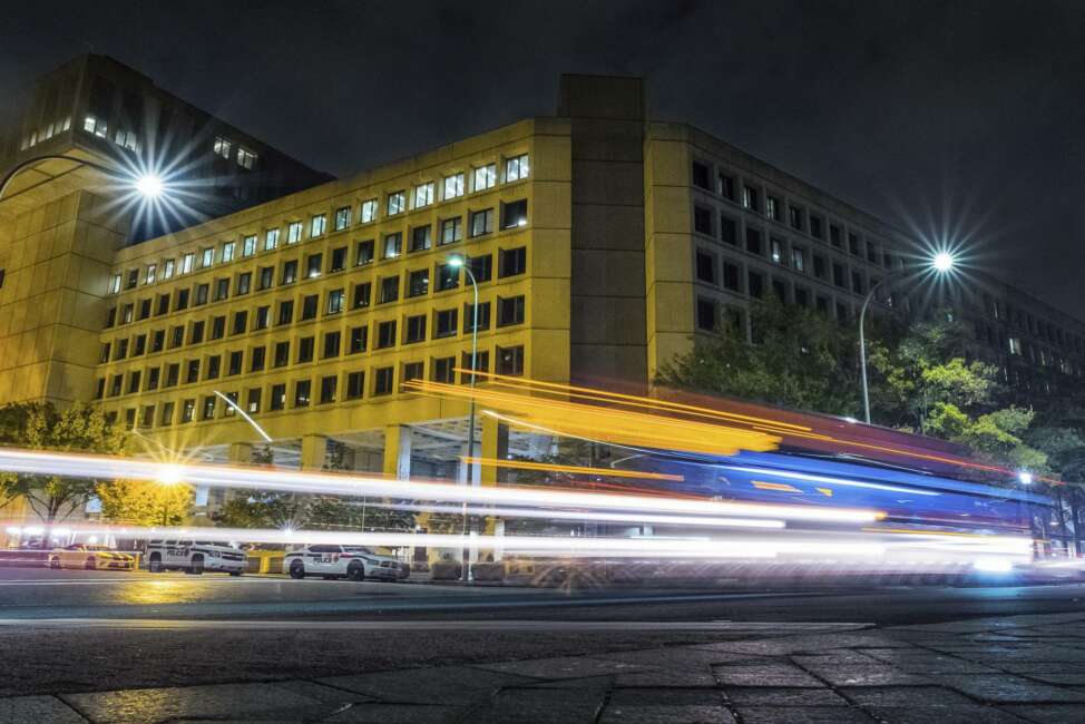 FILE - In this Nov. 1, 2017, file photo, traffic along Pennsylvania Avenue in Washington streaks past the Federal Bureau of Investigation headquarters building. The FBI has been shaken by a series of sexual misconduct cases involving senior leadership over the past few years, including two new claims brought in December 2020 by women who say they were sexually assaulted by supervisors. (AP Photo/J. David Ake, File)