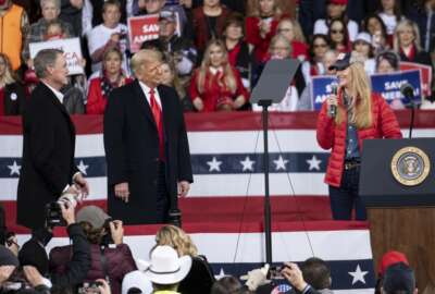 President Donald Trump shares the stage with U.S. Sens. Kelly Loeffler, R-Ga., and David Perdue, R-Ga., who are both facing runoff elections Saturday, Dec. 5, 2020 during a rally in Valdosta, Ga. (AP Photo/Ben Gray)