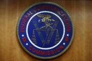 FILE - In this Dec. 14, 2017, file photo, the seal of the Federal Communications Commission (FCC) is seen before an FCC meeting to vote on net neutrality in Washington. The Senate has narrowly approved President Donald Trump’s lame-duck nominee, Nathan Simington, on Tuesday, Dec. 8, 2020, to become a member of the Federal Communications Commission. (AP Photo/Jacquelyn Martin, File)