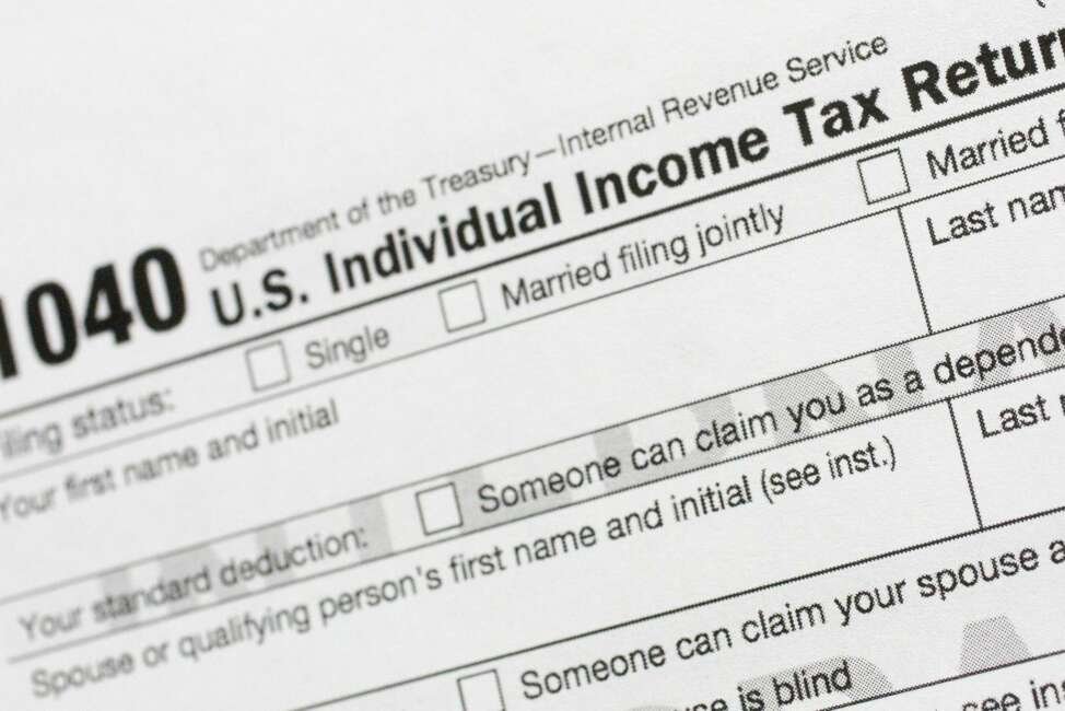 FILE - This July 24, 2018, file photo shows a portion of the 1040 U.S. Individual Income Tax Return form. It’s the time of year to start thinking about taxes - what's ahead and what can be done now to manage. But the upcoming tax filing season is going to be trickier for many Americans due to rampant unemployment, working from home and general upheaval due to COVID-19. (AP Photo/Mark Lennihan, File)