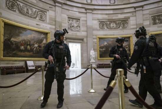 Members of the U.S. Secret Service Counter Assault Team walk through the Rotunda as they and other federal police forces responded as violent protesters loyal to President Donald Trump stormed the U.S. Capitol today, at the Capitol in Washington, Wednesday, Jan. 6, 2021. (AP Photo/J. Scott Applewhite)