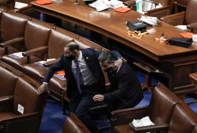 Lawmakers evacuate the floor as protesters try to break into the House Chamber at the U.S. Capitol on Wednesday, Jan. 6, 2021, in Washington. (AP Photo/J. Scott Applewhite)