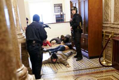 U.S. Capitol Police hold rioters at gun-point near the House Chamber inside the U.S. Capitol on Wednesday, Jan. 6, 2021, in Washington. (AP Photo/Andrew Harnik)