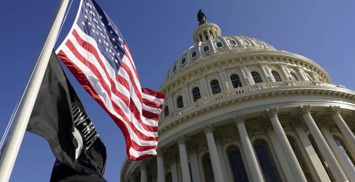 Flags fly on the U.S. Capitol in Washington, Tuesday, Jan. 19, 2021, ahead of the 59th Presidential Inauguration on Wednesday. (AP Photo/Susan Walsh, Pool)