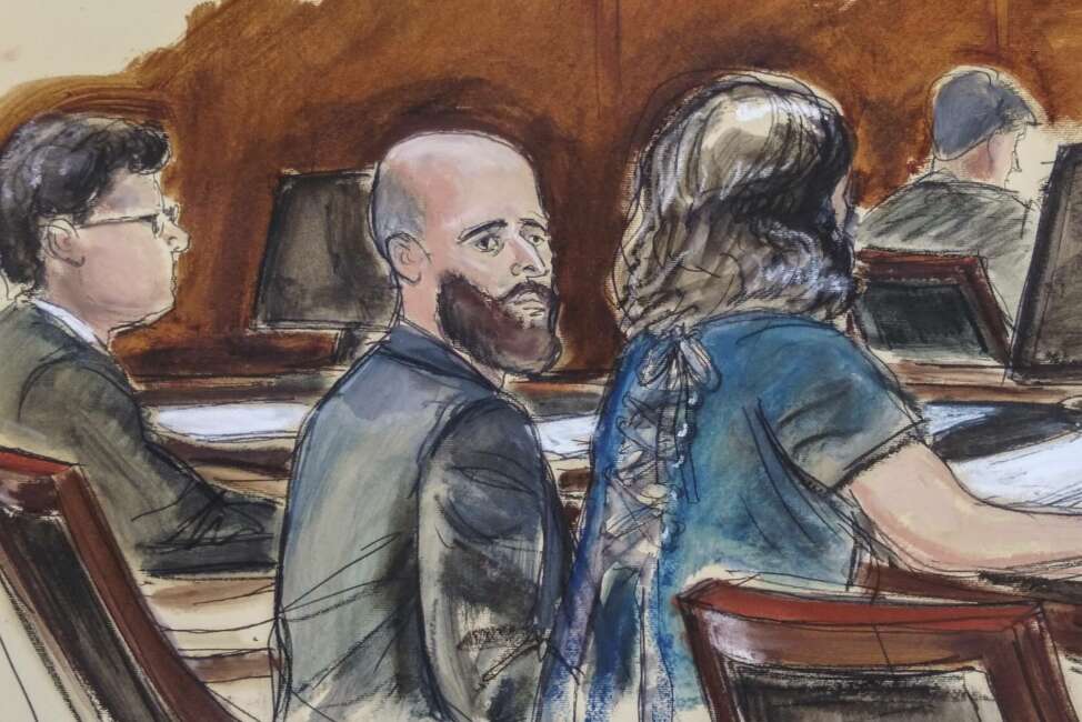 In this Wednesday March 4, 2020 courtroom sketch Joshua Schulte, center, is seated at the defense table flanked by his attorneys during jury deliberations in New York. Joshua Schulte, a former CIA software engineer charged with leaking government secrets to WikiLeaks says it's cruel and unusual punishment that he's awaiting trial in solitary confinement, housed in a vermin-infested cell of a jail unit where inmates are treated like “caged animals." In court papers Tuesday, Jan. 19, 2021 Schulte maintained he is held in conditions “below that of impoverished persons living in third world countries.” (Elizabeth Williams via AP)