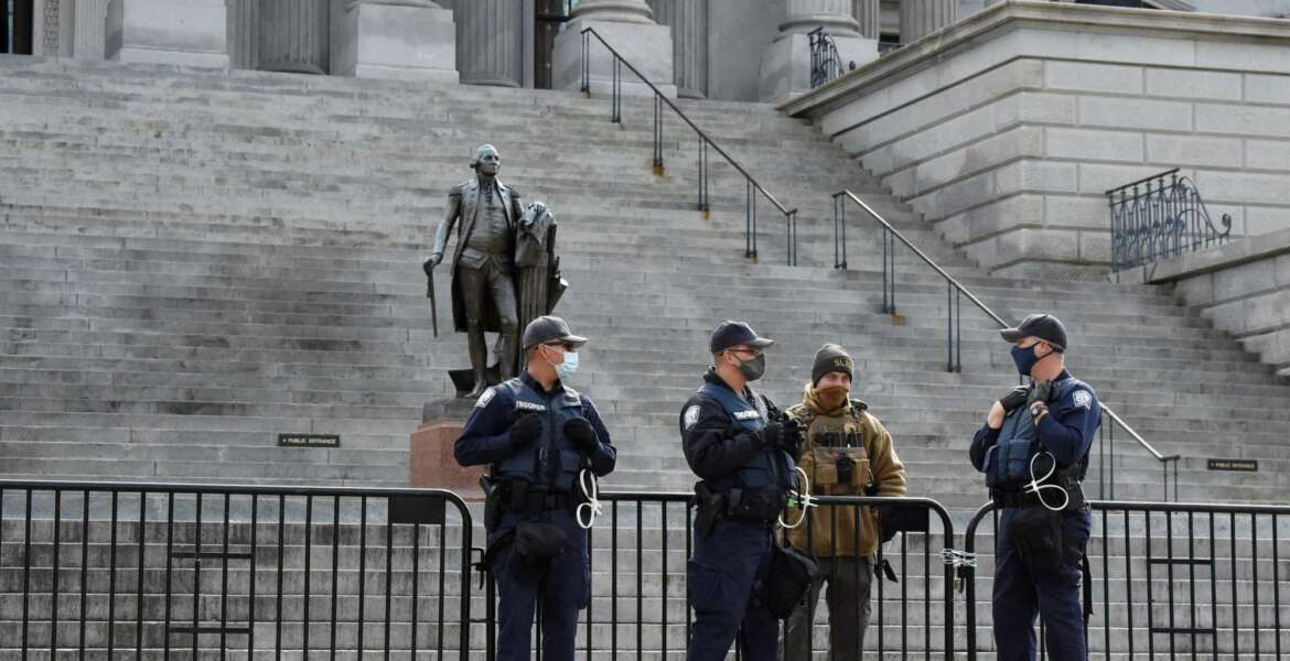 Law enforcement officers stand watch at South Carolina's Statehouse during an expected day of unrest across the country on Sunday, Jan. 17, 2021, in Columbia, S.C. (AP Photo/Meg Kinnard)