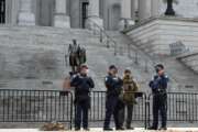 Law enforcement officers stand watch at South Carolina's Statehouse during an expected day of unrest across the country on Sunday, Jan. 17, 2021, in Columbia, S.C. (AP Photo/Meg Kinnard)