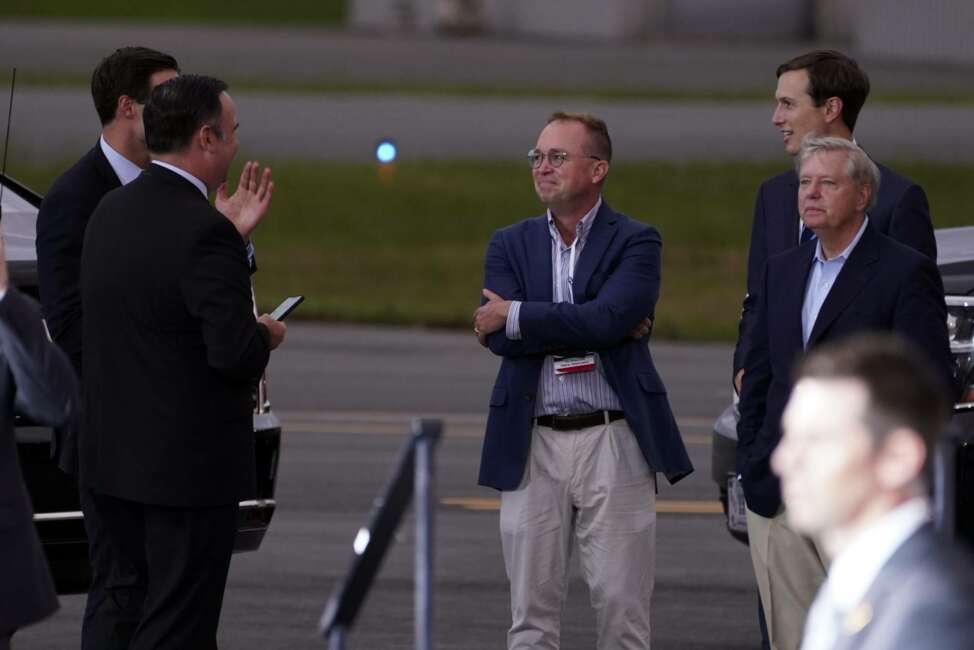 White House social media director Dan Scavino, from left, White House aide John McEntee former acting chief of staff Mick Mulvaney, White House adviser Jared Kushner and Sen. Lindsey Graham, R-S.C., talk as President Donald Trump speaks during a campaign rally at Smith Reynolds Airport, Tuesday, Sept. 8, 2020, in Winston-Salem, N.C. (AP Photo/Evan Vucci)