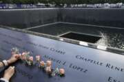 FILE - In this Sept. 11, 2020, file photo, mourners place flowers in the name cut-out of Kyung Hee (Casey) Cho at the National September 11 Memorial and Museum in New York. A U.S. Army soldier was arrested Tuesday, Jan. 19, 2021, in Georgia on terrorism charges after he spoke online about plots to blow up New York City's 9/11 Memorial and other landmarks and attack U.S. soldiers in the Middle East, authorities said. (AP Photo/John Minchillo, File)