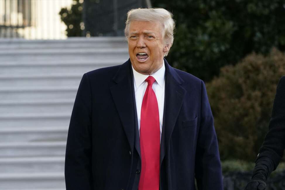 President Donald Trump speaks with reporters as he walks to board Marine One on the South Lawn of the White House, Wednesday, Jan. 20, 2021, in Washington. Trump is en route to his Mar-a-Lago Florida Resort. (AP Photo/Alex Brandon)