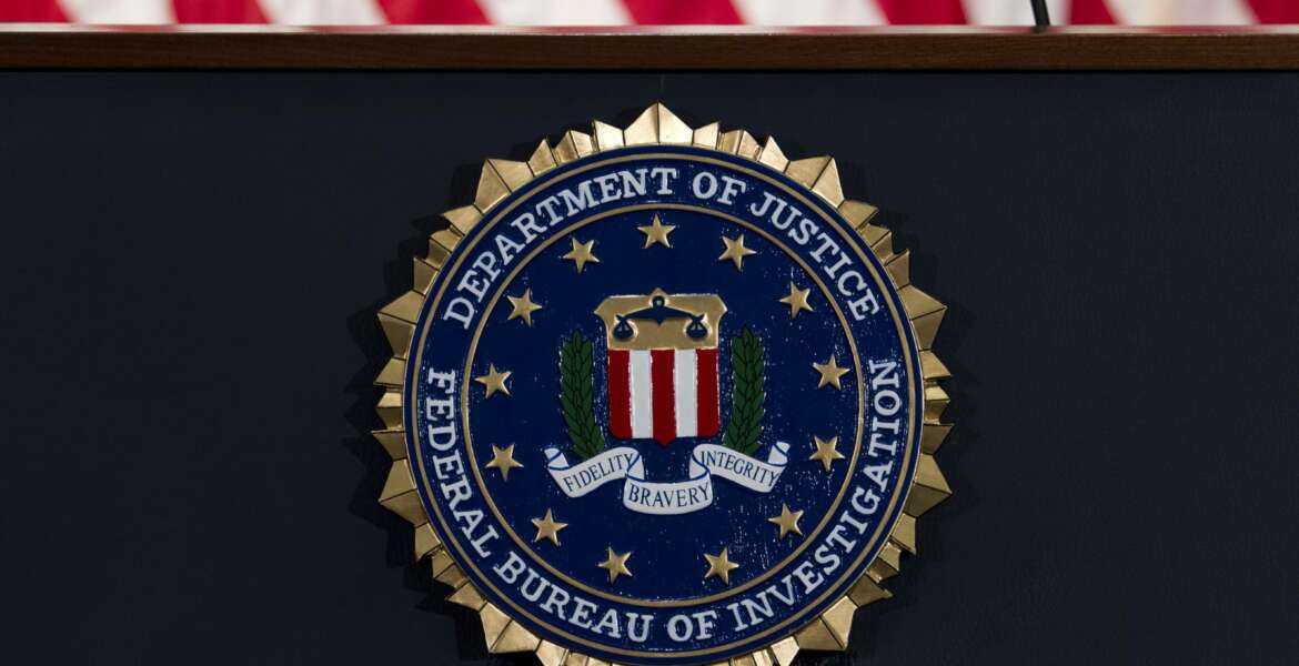 FILE - In this June 14, 2018, file photo, the FBI seal is seen before a news conference at FBI headquarters in Washington. A former FBI lawyer was sentenced to probation for altering a document the Justice Department relied on during its surveillance of a Donald Trump aide during the Russia investigation. (AP Photo/Jose Luis Magana, File)