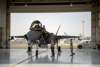 In this Aug. 5, 2019 photo released by the U.S. Air Force, an F-35 fighter jet pilot and crew prepare for a mission at Al-Dhafra Air Base in the United Arab Emirates. The Biden administration has put a temporary hold on several major foreign arms sales initiated by former President Donald Trump. Officials say that among the deals being paused is a massive $23 billion transfer of stealth F-35 fighters to the United Arab Emirates. (Staff Sgt. Chris Thornbury/U.S. Air Force via AP)